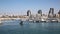 The yacht sails to the Marina of the yacht club in Ashdod against the backdrop of the city landscape