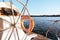 Yacht steering wheel on sunny day wallpaper. Water sport background. White boat cruise banner. Metal rudder on ship. Orange