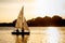 Yacht with two white sails and people on the lake. Sunset on the water. Summer calm rest on lake, yachting hobby