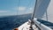 Yacht Under Sails Speeds Across the Sea Toward the Horizon on a Sunny Summer Day. Vacation and Yachting Sport