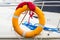 Yachting, blue and red rope with orange lifebuoy on sailboat