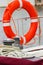 Yachting, colorful rope with orange lifebuoy on sailboat