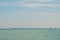 Yachting competition on Lake Balaton, Hungary. Two sailing boats on foreground under beautiful blue sky with clouds