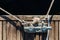 Yachting detail, rope and mooring double cross bollard on bridge in port of sailing. Wooden pier