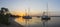 Yachts anchored near the island at sunrise