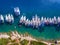 Yachts ancored in a bay with clear blue waters aerial view