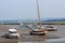 Yachts and craft beached on a tidal inlet