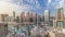 Yachts in Dubai Marina flanked by the Al Rahim Mosque and residential towers and skyscrapers aerial timelapse.