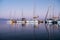 Yachts in the harbor at dawn. Beautiful reflection. Nature background. Concept of silence, relax and tranquility.