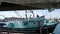 Yachts in harbor village, ocean coast marina. Men work on fisherman boat for fishing. California USA