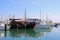 Yachts in Larnaca port, Cyprus. One black boat is different from the others - it looks like a pirate ship