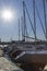 Yachts moored to the pier. Dusk. Setting sun with long rays in the sky