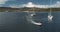 Yachts and motor boat at sea bay of green island coast aerial. Summer passenger cruise on sailboats