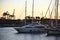 Yachts and motor boats in La Marina de Valencia. Luxury yacht and fishing motorboat in yacht club on sunset. Skiff and Sailboat in