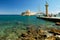 Yachts and old lighthouse in the harbor