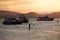 Yachts and people practicing stand up paddle, during the sunset, in Guaruja, Brazil