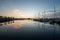 Yachts and sailboats docked in Dinner Key Marina in Miami in morning twilight.