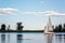 Yachts at sailing regatta. Beautiful ship yachts with white sails in the Dnieper river on a background of the blue sky with clouds