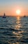 Yachts sailing at sunset