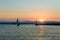 Yachts sailing at sunset