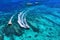 Yachts at the sea in Bali, Indonesia. Aerial view of luxury floating boat on transparent turquoise water at sunny day. Summer seas