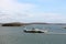 Yachts, seagoing vessels and tugboats on the roads of the port of Gladstone, Australia. December, 2019.