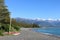 Yachts on shore at Kaikoura with snow on mountains