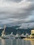 Yachts stand at the mooring of the marina against the backdrop of mountains in the fog