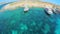 Yachts with tourists stand near a picturesque sea shore. Aerial view. Malta