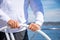 Yachtsman holding the wheel on a sailing boat during yachting, Croatia