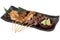 Yakitori Japanese-Style Grilled Chicken Skewers with chicken and internal organ served with sliced lime.