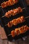 Yakitori skewers of chicken on a grill pan close-up. vertical to