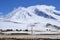 Yaks in beautiful landscape with snow covered mountains at Karakorum highway in Xinjiang, China