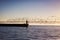 Yalta lighthouse at dawn surrounded by a flock of small birds. Yalta embankment, Crimea.