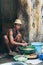 Yangon, Myanmar - March 2019: butcher cleaning the guts at the open street stall