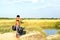 Yangon, Myanmar - November 18, 2015: Water carrier with two buckets getting water in the countryside