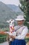 YANQUE, COLCA VALLEY, PERU - JANUARY 20, 2018: Young peruvian woman holding a baby alpaca with typical costume in Yanque, Peru