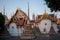 Yard in a Buddhist temple with beautiful stupas and roofs of buildings with ornaments.