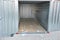 In the yard there is a large-capacity container with a wooden floor. serves as a garage, tool storage, or temporary home for conve