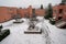 Yard in winter under snow. The snow has not been cleared away, there are shoe imprints.