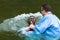 Yardenit, Israel - 29 Decembre 2012: a man gets baptised in the Jordan River. The man`s head splashes into the water