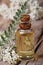 Yarrow oil in a bottle with flowers vertical macro