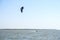 Yasenskaya ferry. Russia. August 18, 2020. Athletic muscular tanned male kitesurfer rushes over the sea waves and jumps