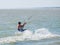 Yasenskaya ferry. Russia. August 18, 2020. Athletic muscular tanned male kitesurfer rushes over the sea waves and jumps