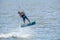 Yasenskaya ferry. Russia. August 18, 2020. Athletic muscular tanned male kitesurfer rushes over the sea waves and jumps