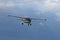 Yaslo, Poland - july 1 2018: A light sport turboprop aircraft flies across the sky among the rainy clouds. Landing in difficult we