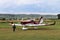 Yaslo, Poland - july 3 2018: The little boy runs along the grassy airfield to the light two-seater tuppovintovom airplane. Raising