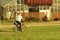 Yaslo, Poland - july 9 2018: The man is riding a bicycle on an road amidst summer greens in the rays of the sun. Healthy lifest