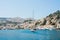 Yatch arriving at Symi harbour. View of the colorful village on a summer day. Dodecanese, Greece