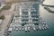 Yatch harbor marina pier and boat dock yatchs and vessels awaiting the open sea. Aerial drone view looking straight down above T-